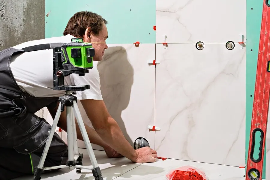 man-laying-ceramic-tiles